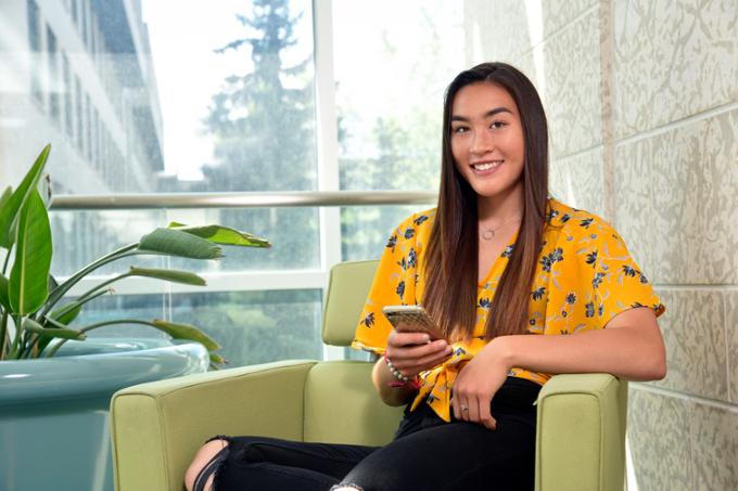 Female student sitting in a chair inside the Research and Innovation Centre