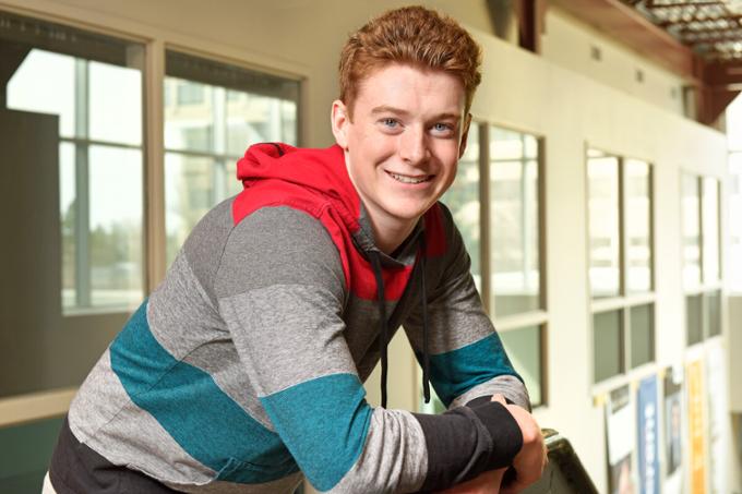 Student leaning on railing