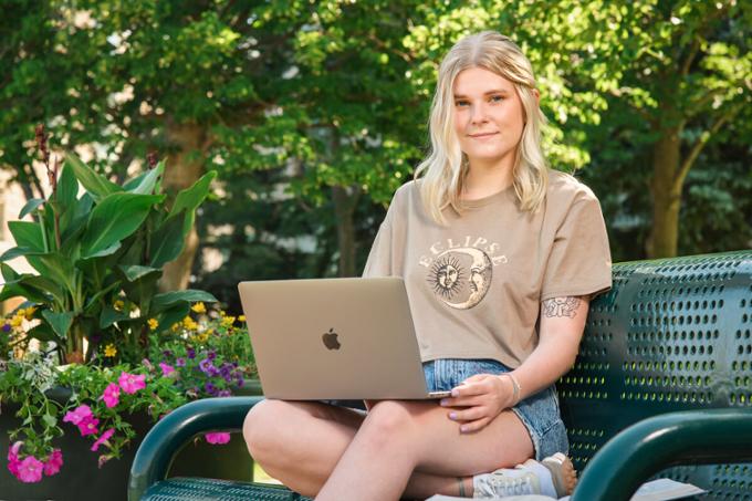 Students outside on computer