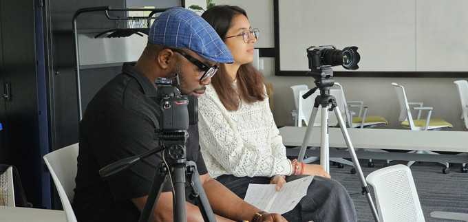 Interview shot with Vanshita, CJ, and cameras