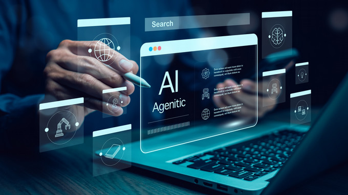 Person using a laptop with AI agent interface and floating digital icons.