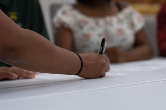 student writing on paper