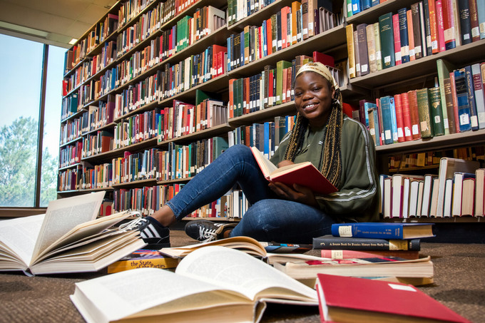 student sitting in a library