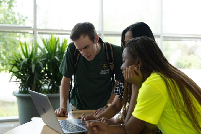 students looking at computer