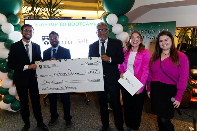 Graduate Student posing with cheques