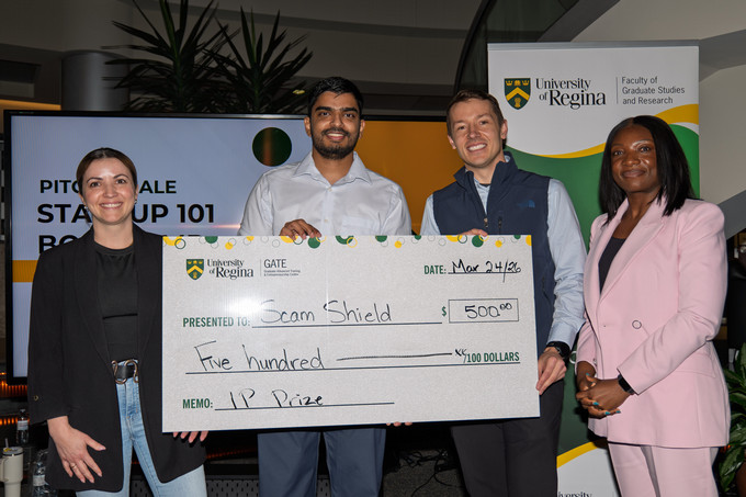 One IP Award Winner Holding Cheque