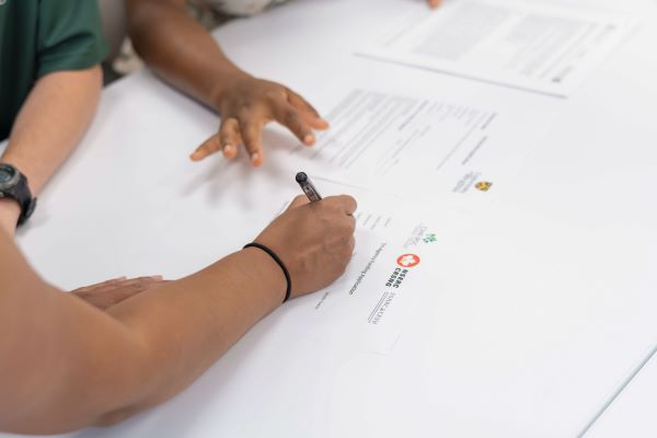Hand Using a Pen to Write on Paper