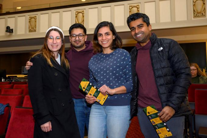 Four students on stage at Three-Minute Thesis event