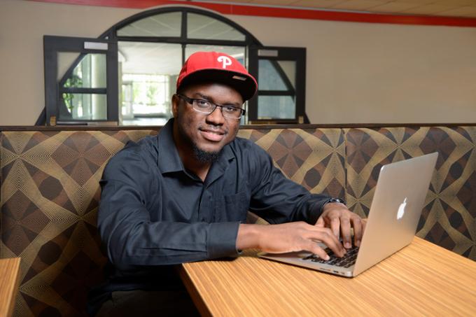 student sitting at table with laptop