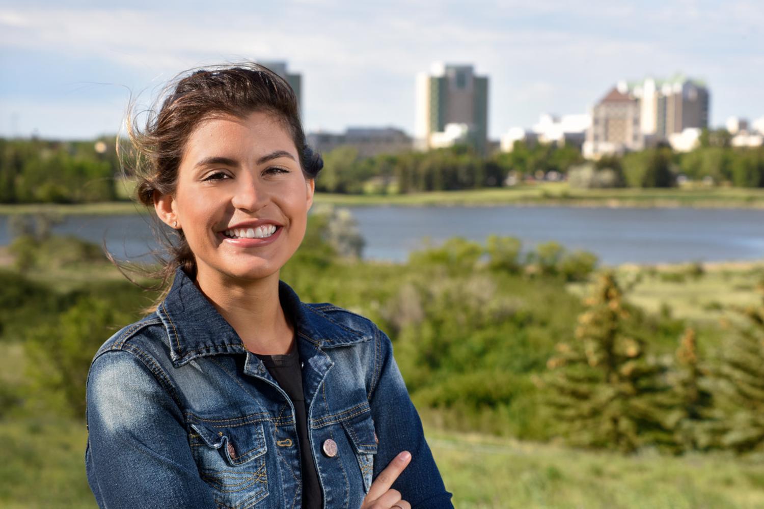 Woman standing in front of campus landscape