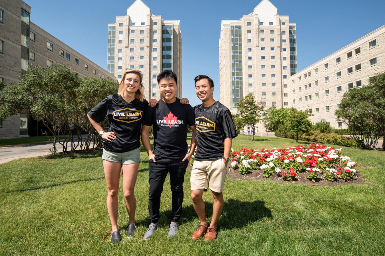 Three students standing outside on campus