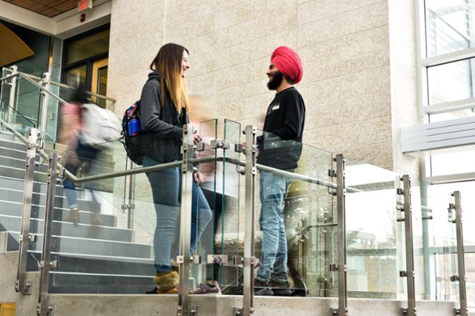 Two people standing and talking 