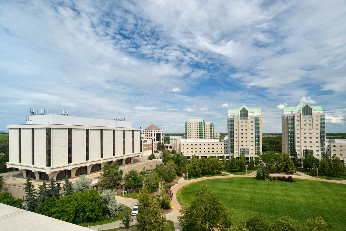 Three students standing outside on campus