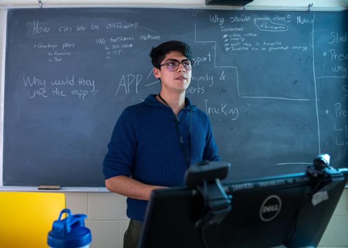 A participant is discussing an idea in his team's room. 