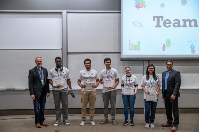 Team 1 poses with their certificates after taking second place. Saqib Khan and Mark Borgares are in the picture with them.
