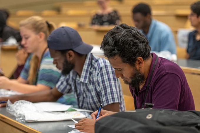 Participants taking notes during the wicked problem presentation.