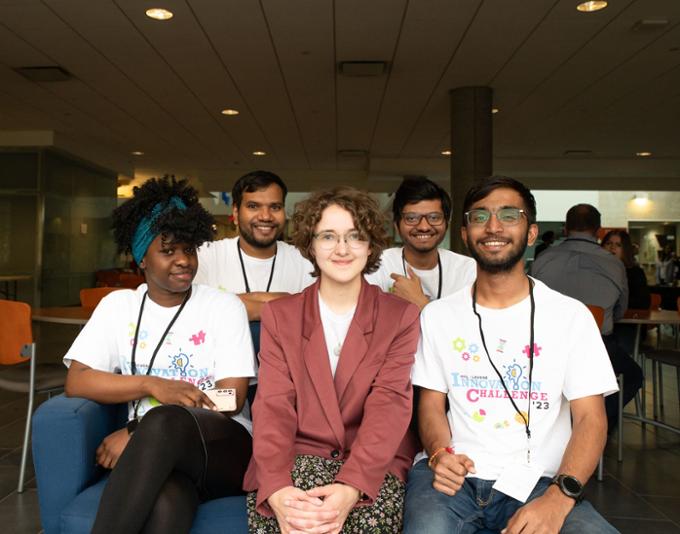 A team of participants pose for a group picture.