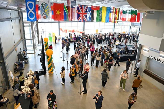 Many attendees walk around the foyer of the conference