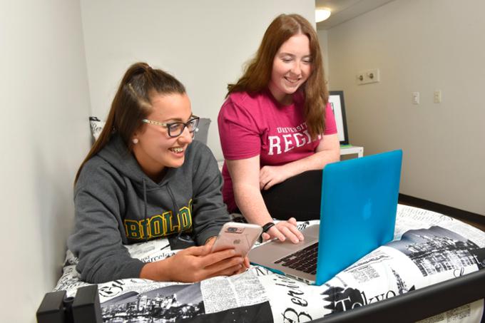 students with laptop in residence