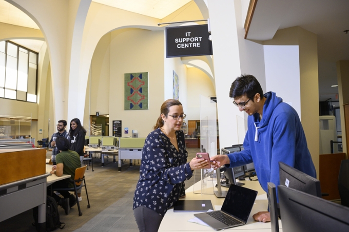 student getting help at IT Support in library