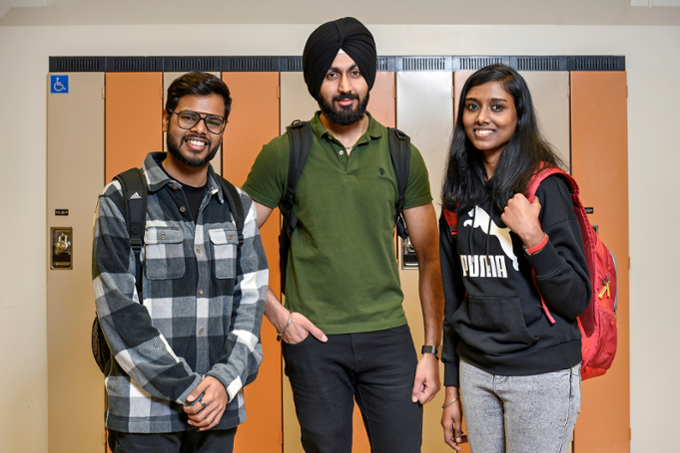 three students smiling