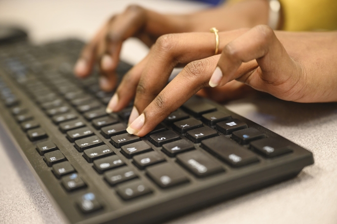 fingers typing on keyboard