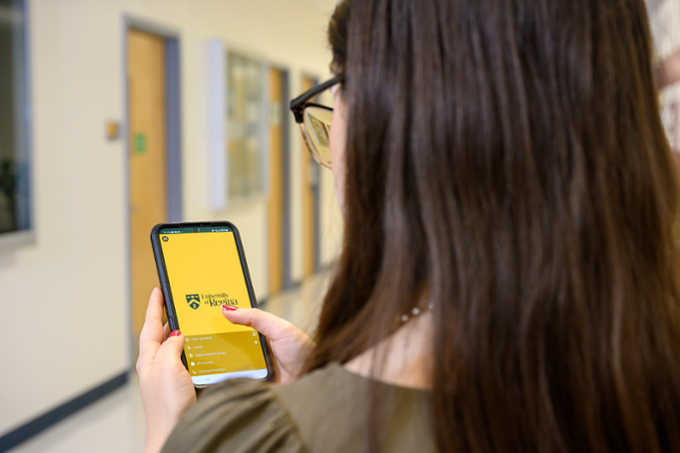 Student looking at UR mobile app