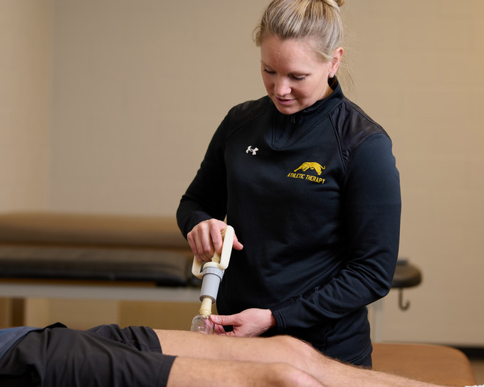 Athletic Therapist using the cupping treatment on a patient