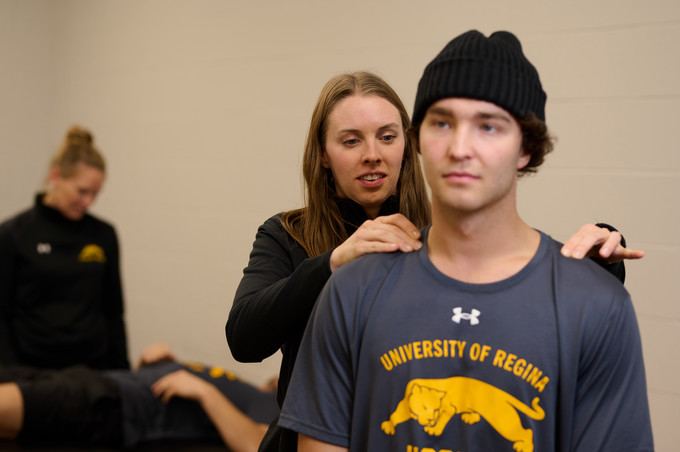 Health professional conducting an initial assessment on a patient.