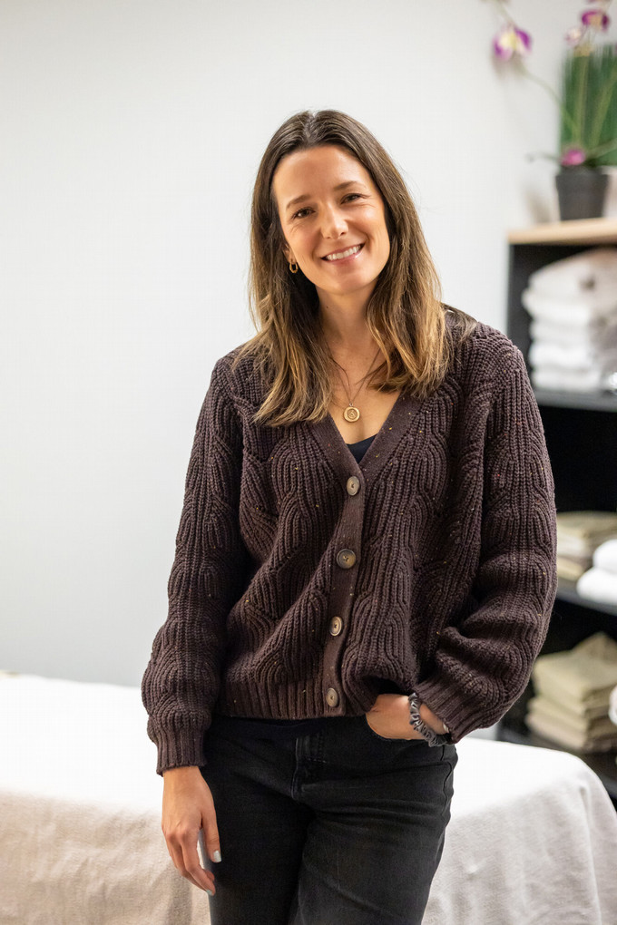A smiling headshot of Dr. Nicole Mitchelson standing in her office