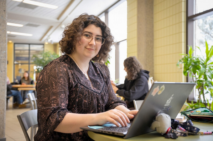 A person sitting and using the laptop
