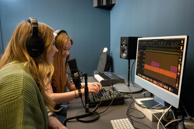 Two students working with a soundboard