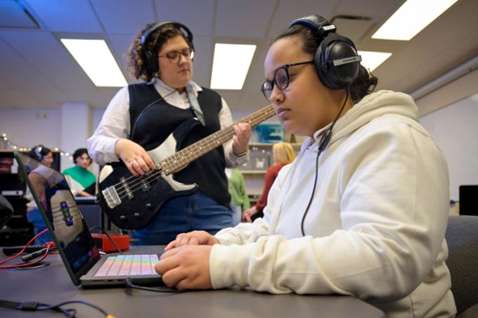 Students making music with a guitar