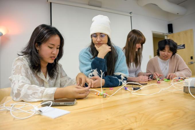 Four students working on gadgets