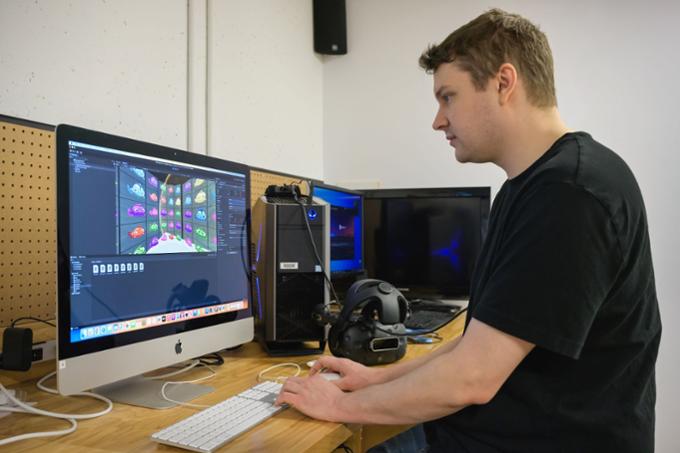 Student creating a visual art project on a computer