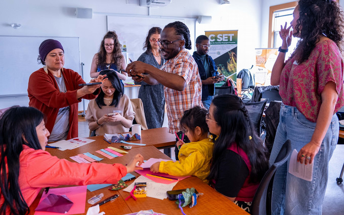a group of people working around a table