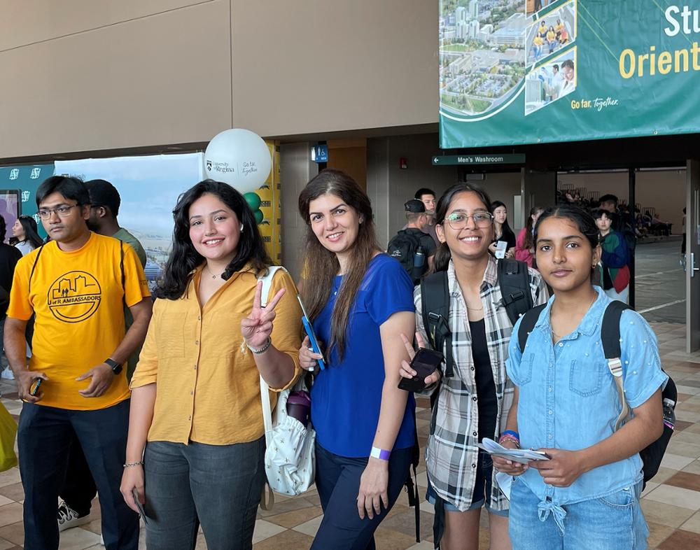 Four smiling female students and a student ambassador