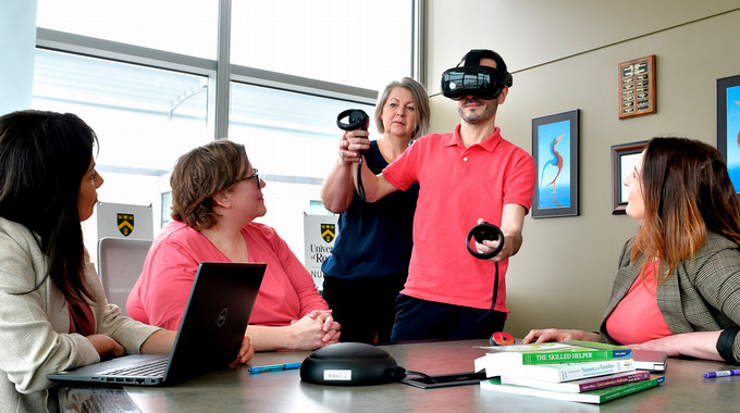 graduate student testing virtual reality headset