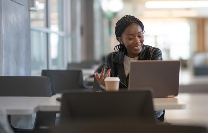 smiling woman at laptop in study area