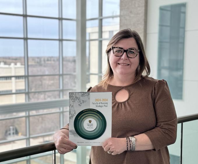 Dean of nursing holding strategic plan