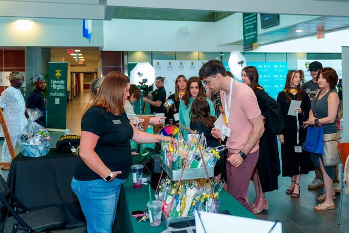 candid photo of male nursing grad looking at prize table