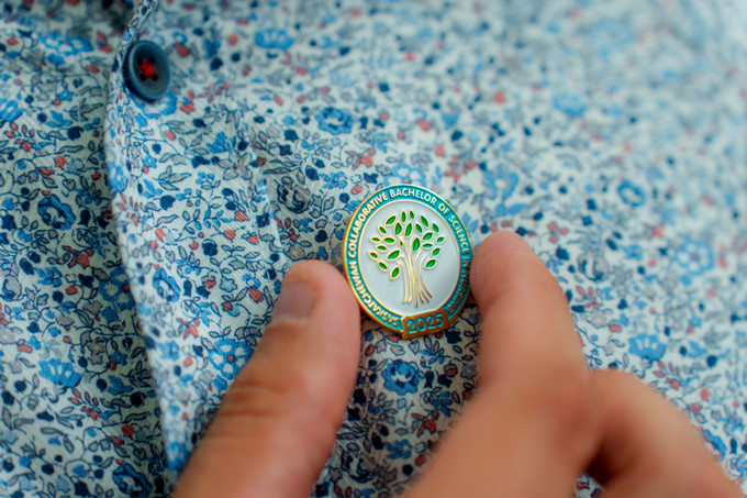 close up photo of the nursing pin on colourful shirt