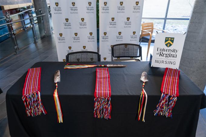 table with metis sash and eagle feather