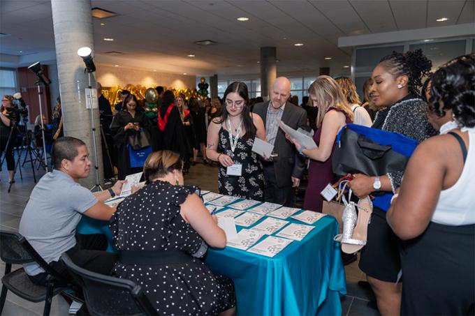 nursing graduates picking up their nursing pins