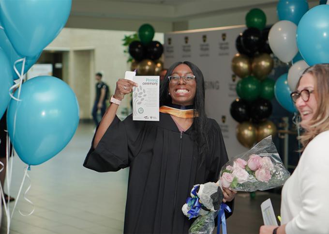 smiling graduate with nursing pin