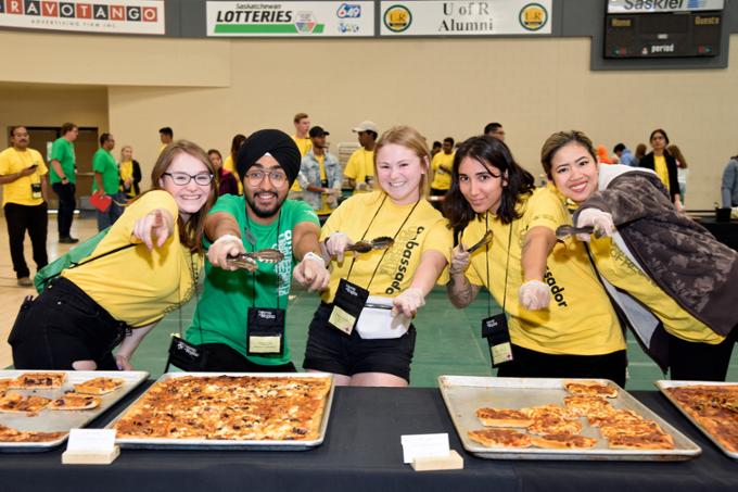 Students serving pizza.