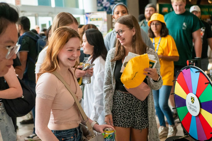A person smiling in a group of people