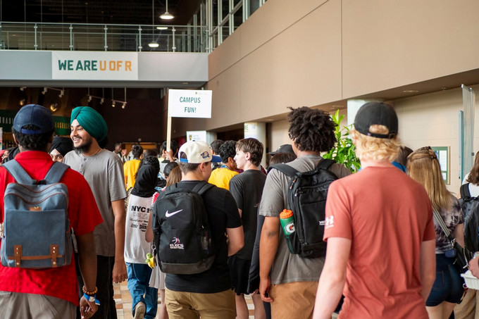 people smiling and walking in a hallway