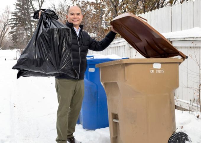 A front-end loader moving trash at the city landfill