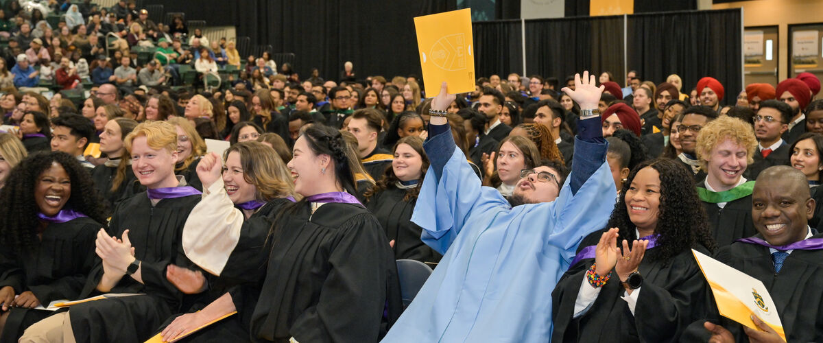 a large group of students at convocation in their gowns